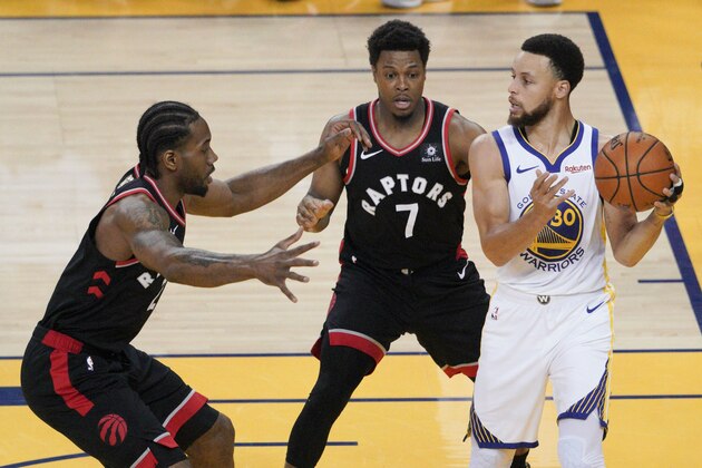 Golden State Warriors guard Stephen Curry , right, is defended by Toronto Raptors forward Kawhi Leonard, left, and guard Kyle Lowry (7) during the first half of Game 3 of basketball's NBA Finals in Oakland, Calif., Wednesday, June 5, 2019. (AP Photo/Tony Avelar)