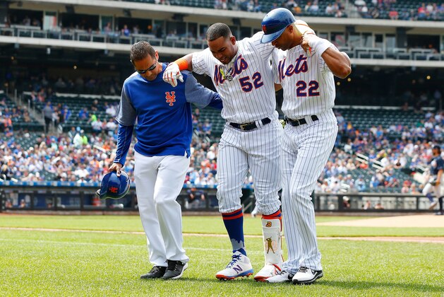 NEW YORK, NY - APRIL 27:  (NEW YORK DAILIES OUT)   Yoenis Cespedes #52 of the New York Mets is heped off the field after an injury against the Atlanta Braves by trainer Ray Ramirez and first base coach Tom Goodwin #22 at Citi Field on April 27, 2017 in the Flushing neighborhood of the Queens borough of New York City. The Braves defeated the Mets 7-5.  (Photo by Jim McIsaac/Getty Images)