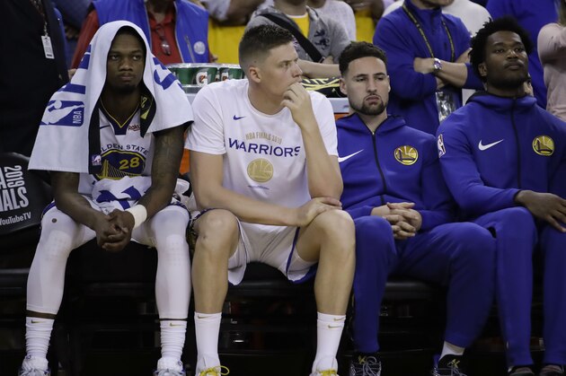 Golden State Warriors' Alfonzo McKinnie, from left, sits on the bench with Jonas Jerebko, Klay Thompson and Damian Jones during the second half of Game 3 of basketball's NBA Finals against the Toronto Raptors in Oakland, Calif., Wednesday, June 5, 2019. (AP Photo/Ben Margot)