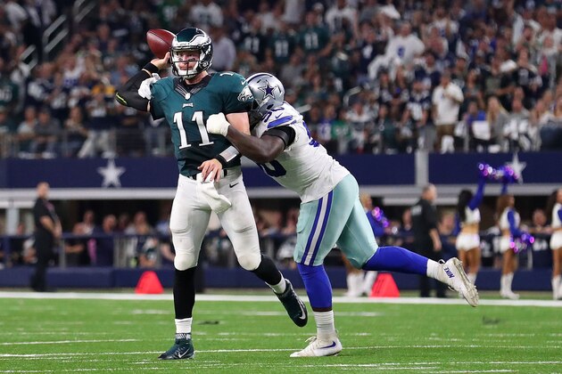 ARLINGTON, TX - OCTOBER 30:  Carson Wentz #11 of the Philadelphia Eagles throws the ball before the tackle of Demarcus Lawrence #90 of the Dallas Cowboys in the third quarter during a game between the Dallas Cowboys and the Philadelphia Eagles at AT&T Stadium on October 30, 2016 in Arlington, Texas.  (Photo by Tom Pennington/Getty Images)