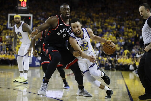 Golden State Warriors guard Stephen Curry (30) dribbles against Toronto Raptors center Serge Ibaka (9) during the second half of Game 3 of basketball's NBA Finals in Oakland, Calif., Wednesday, June 5, 2019. (AP Photo/Ben Margot)