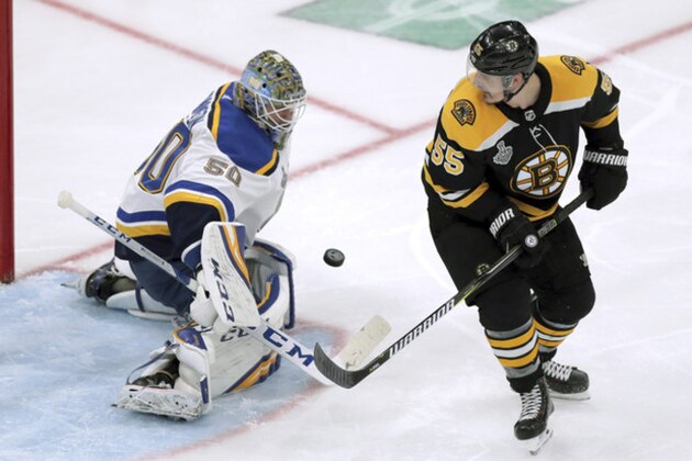 St. Louis Blues goaltender Jordan Binnington, left, stops an attempt by Boston Bruins' Noel Acciari during the second period in Game 5 of the NHL hockey Stanley Cup Final, Thursday, June 6, 2019, in Boston. (AP Photo/Charles Krupa)
