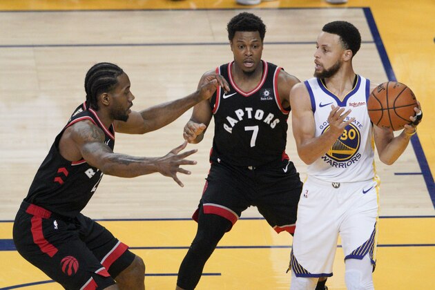 Golden State Warriors guard Stephen Curry , right, is defended by Toronto Raptors forward Kawhi Leonard, left, and guard Kyle Lowry (7) during the first half of Game 3 of basketball's NBA Finals in Oakland, Calif., Wednesday, June 5, 2019. (AP Photo/Tony Avelar)