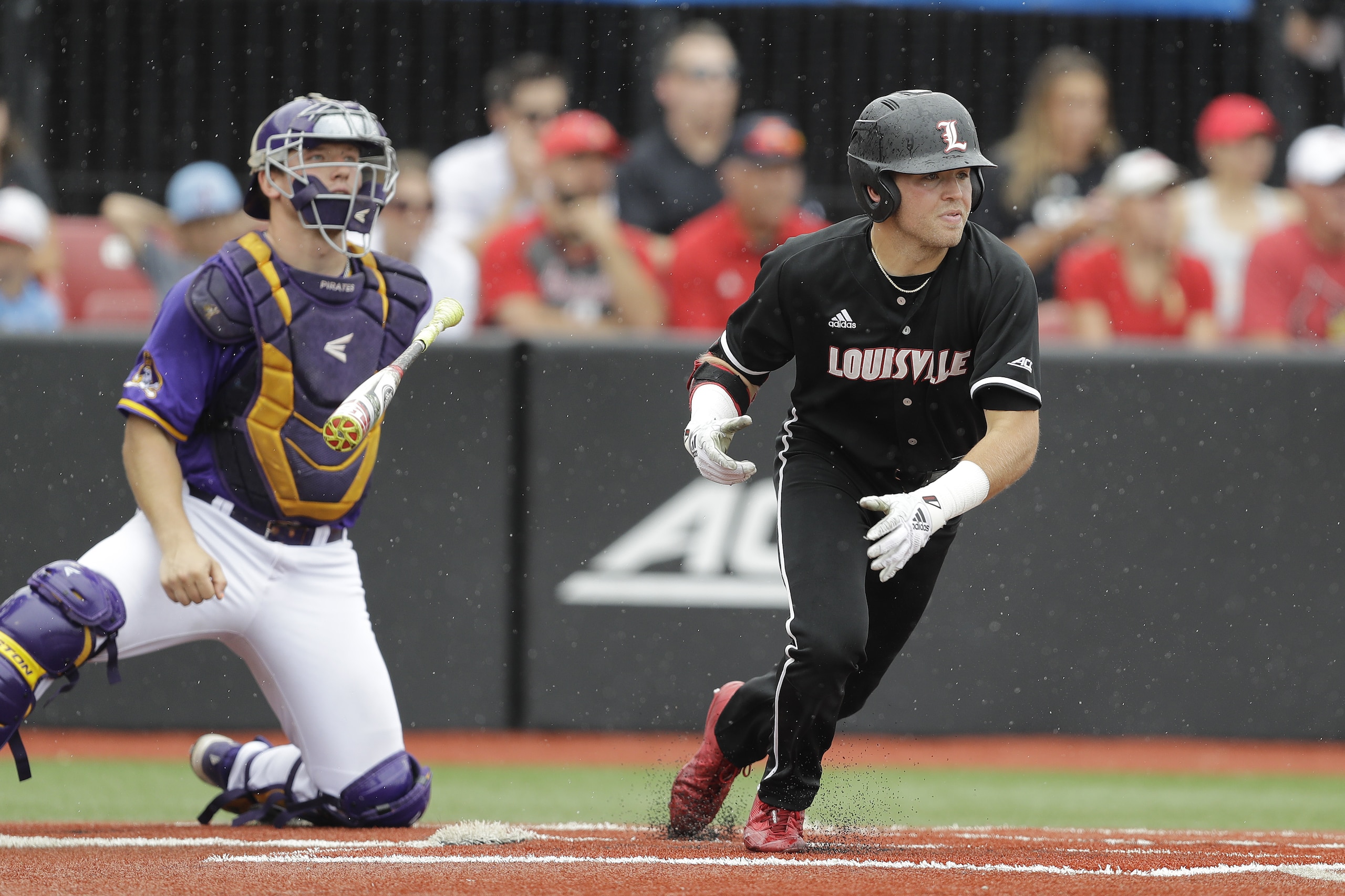 Louisville's Jake Snider tosses his bat after hitting a single during the fourth inning in Game 1 of an NCAA college baseball super regional tournament against East Carolina, Friday, June 7, 2019, in Louisville, Ky. (AP Photo/Darron Cummings)