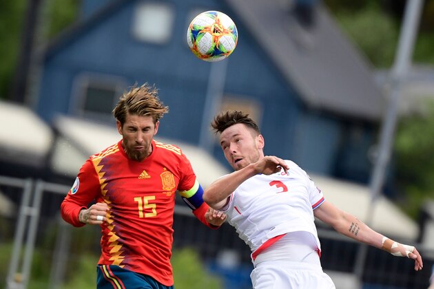 Spain's defender Sergio Ramos (L) challenges Faroe Islands' defender Viljormur Davidsen  during the UEFA Euro 2020 group F qualifying football match between Faroe Islands and Spain at the Trosvollur stadium in Torshavn on June 7, 2019. (Photo by JAVIER SORIANO / AFP)        (Photo credit should read JAVIER SORIANO/AFP/Getty Images)