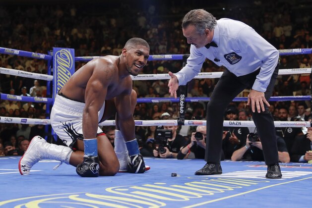 Anthony Joshua waits during the referee's count after he was knocked down during the seventh round of a heavyweight championship boxing match against Andy Ruiz on Saturday, June 1, 2019, in New York. Ruiz won in the seventh round. (AP Photo/Frank Franklin II)