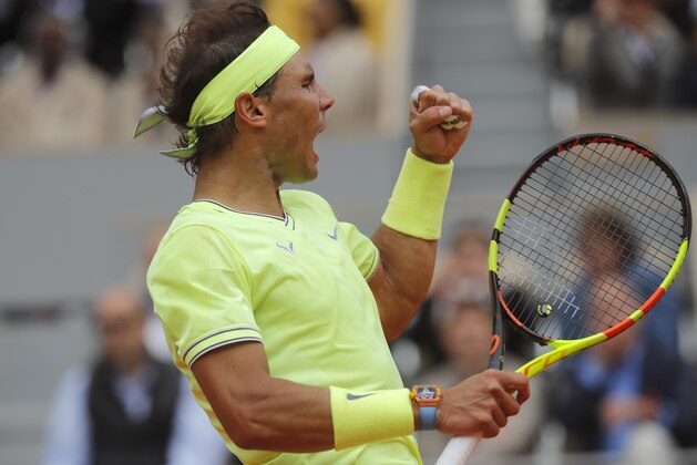 Spain's Rafael Nadal clenches his fist after scoring a point against Switzerland's Roger Federer during their semifinal match of the French Open tennis tournament at the Roland Garros stadium in Paris, Friday, June 7, 2019. (AP Photo/Michel Euler)