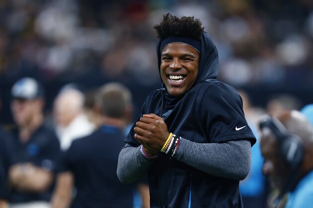 Carolina Panthers quarterback Cam Newton, who was inactive for the game, celebrates a touchdown reception from the sideline in the first half of an NFL football game against the New Orleans Saints in New Orleans, Sunday, Dec. 30, 2018. (AP Photo/Butch Dill)
