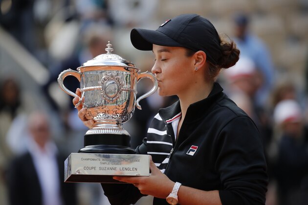 Australia's Ashleigh Barty kisses the trophy as she celebrates winning her women's final match of the French Open tennis tournament against Marketa Vondrousova of the Czech Republic in two sets 6-1, 6-3, at the Roland Garros stadium in Paris, Saturday, June 8, 2019. (AP Photo/Christophe Ena)