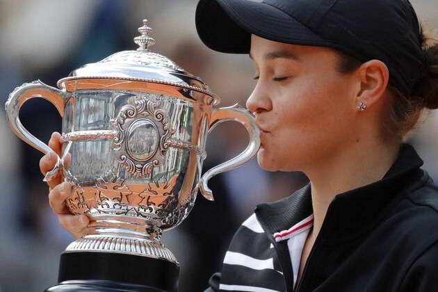 Australia's Ashleigh Barty kisses the trophy as she celebrates winning her women's final match of the French Open tennis tournament against Marketa Vondrousova of the Czech Republic in two sets 6-1, 6-3, at the Roland Garros stadium in Paris, Saturday, June 8, 2019. (AP Photo/Christophe Ena)