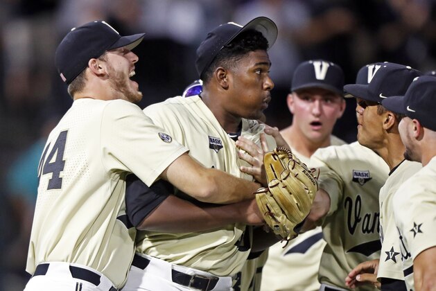 Vanderbilt's Kumar Rocker (80) is congratulated by teammates after he threw a no-hitter against Duke in an NCAA college baseball tournament super regional game Saturday, June 8, 2019, in Nashville, Tenn. Vanderbilt won 3-0.  (AP Photo/Wade Payne)