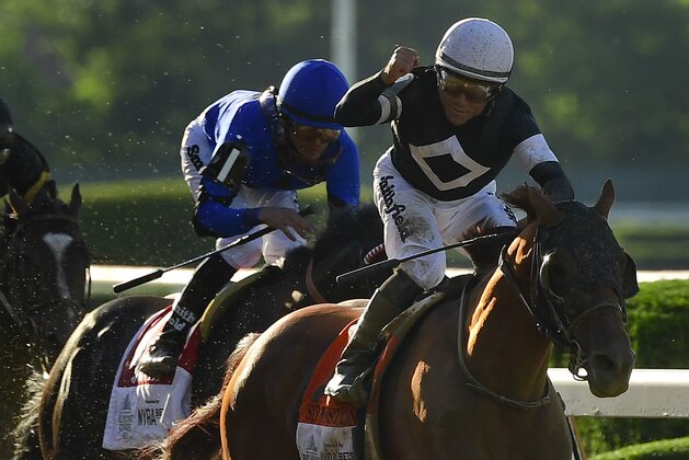 Jockey Joel Rosario, right, atop Sir Winston (7) celebrates after winning the 151st running of the Belmont Stakes horse race, Saturday, June 8, 2019, in Elmont, N.Y. (AP Photo/Steven Ryan)