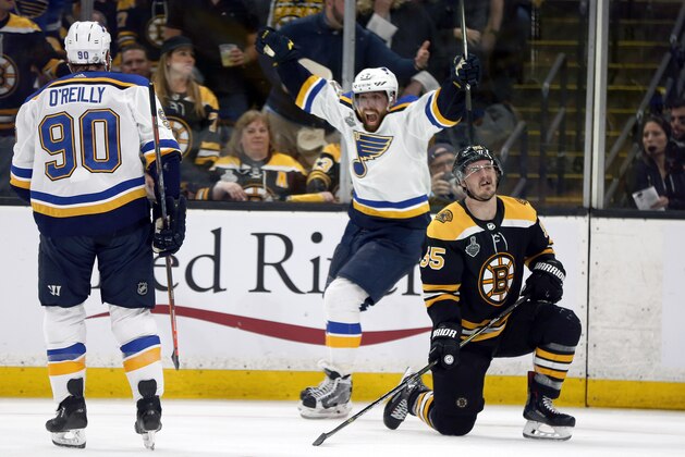 St. Louis Blues' David Perron, center, celebrates his goal behind Boston Bruins' Noel Acciari, right, during the third period in Game 5 of the NHL hockey Stanley Cup Final, Thursday, June 6, 2019, in Boston. (AP Photo/Michael Dwyer)