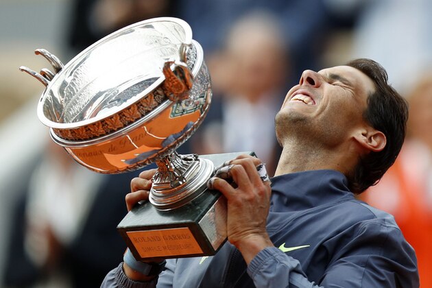 Spain's Rafael Nadal lifts the cup after defeating Austria's Dominic Thiem in their men's final match of the French Open tennis tournament at the Roland Garros stadium in Paris, Sunday, June 9, 2019. Nadal won 6-3, 5-7, 6-1, 6-1. (AP Photo/Pavel Golovkin)