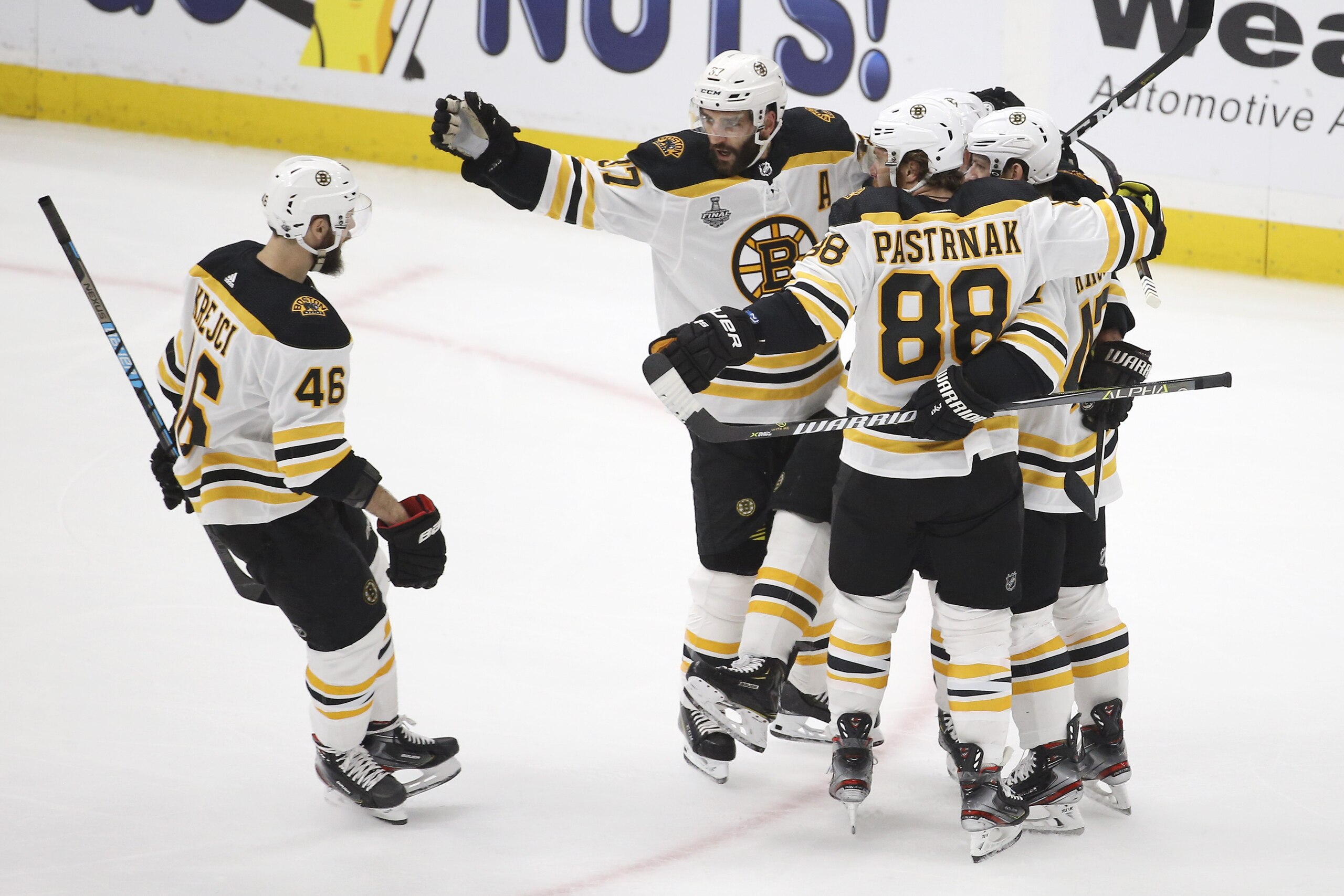 Boston Bruins' David Krejci (46), of the Czech Republic, celebrates with Patrice Bergeron (37) and David Pastrnak (88), of the Czech Republic, after teammate Brad Marchand scored a goal against the St. Louis Blues during the first period of Game 6 of the NHL hockey Stanley Cup Final Sunday, June 9, 2019, in St. Louis. (AP Photo/Scott Kane)