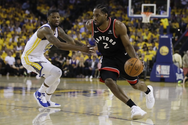 Toronto Raptors forward Kawhi Leonard (2) dribbles against Golden State Warriors forward Alfonzo McKinnie during the first half of Game 3 of basketball's NBA Finals in Oakland, Calif., Wednesday, June 5, 2019. (AP Photo/Ben Margot)