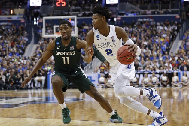 Duke forward Cam Reddish (2) drives around Michigan State forward Aaron Henry (11) during the first half of an NCAA men's East Regional final college basketball game in Washington, Sunday, March 31, 2019. (AP Photo/Patrick Semansky)