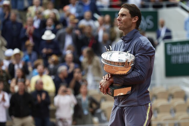 PARIS, FRANCE - JUNE 09: Rafael Nadal of Spain celebrates with the trophy following the mens singles final against Dominic Thiem of Austria during Day fifteen of the 2019 French Open at Roland Garros on June 09, 2019 in Paris, France. (Photo by Quality Sport Images/Getty Images)