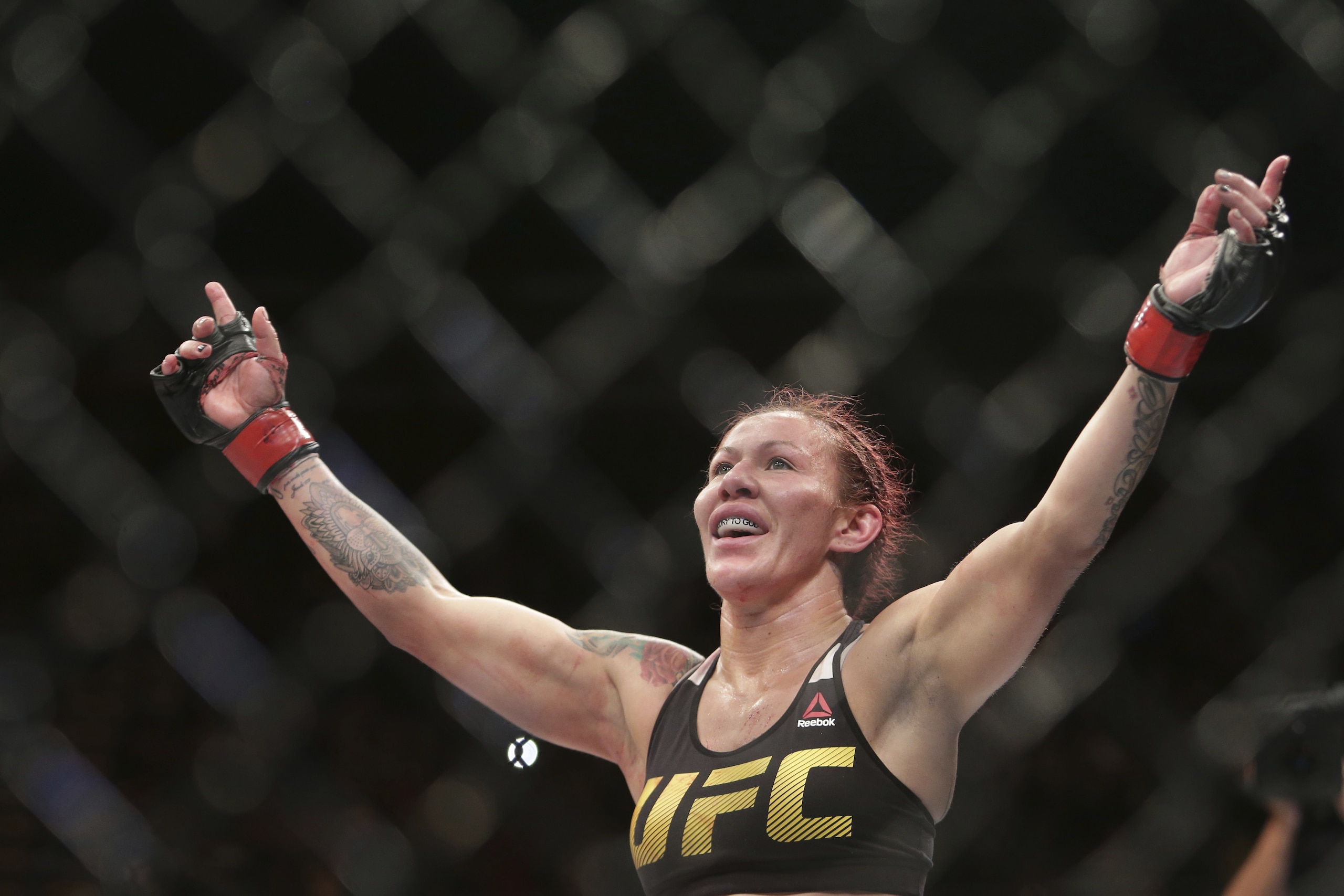FILE - In this Sept. 25, 2016, file photo, Brazil's Cris “Cyborg” Justino celebrates after defeating Sweden's Lina Lansberg during a UFC Fight Night mixed martial arts bout in Brasilia, Brazil. Justino agreed to make a title defense against Yana Kunitskaya, of Russia, on short notice in the headlining bout at UFC 222 because she believes champions should be willing to fight anywhere at any time. (AP Photo/Eraldo Peres, File)