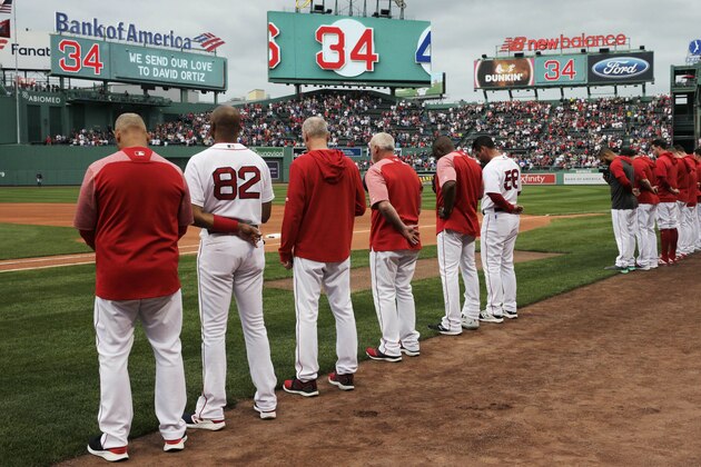 The Boston Red Sox and fans pause for a moment for former Red Sox designated hitter David Ortiz, who was shot Sunday evening in the Dominican Republic, prior to a baseball game against the Texas Rangers at Fenway Park in Boston, Monday, June 10, 2019. Ortiz is expected to return to the area to be treated at a Boston hospital. (AP Photo/Charles Krupa)