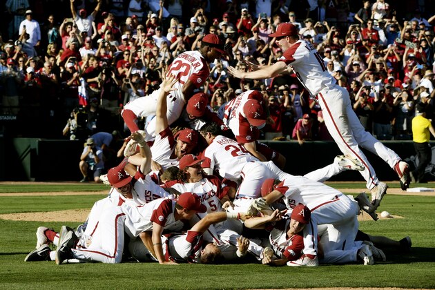 Arkansas players celebrate their win over Mississippi after Game 3 at an NCAA college baseball super regional tournament Monday, June 10, 2019, in Fayetteville, Ark. (AP Photo/Michael Woods)