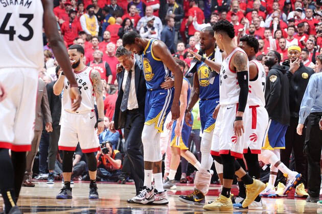 TORONTO, CANADA - JUNE 10: Kevin Durant #35 of the Golden State Warriors is assisted off court after injuring his leg against the Toronto Raptors during Game Five  of the NBA Finals on June 10, 2019 at Scotiabank Arena in Toronto, Ontario, Canada. NOTE TO USER: User expressly acknowledges and agrees that, by downloading and/or using this photograph, user is consenting to the terms and conditions of the Getty Images License Agreement. Mandatory Copyright Notice: Copyright 2019 NBAE (Photo by Nathaniel S. Butler/NBAE via Getty Images)