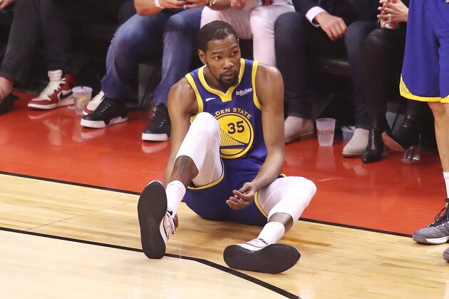 TORONTO, ONTARIO - JUNE 10:  Kevin Durant #35 of the Golden State Warriors reacts after sustaining an injury during the second quarter against the Toronto Raptors during Game Five of the 2019 NBA Finals at Scotiabank Arena on June 10, 2019 in Toronto, Canada. NOTE TO USER: User expressly acknowledges and agrees that, by downloading and or using this photograph, User is consenting to the terms and conditions of the Getty Images License Agreement. (Photo by Claus Andersen/Getty Images)