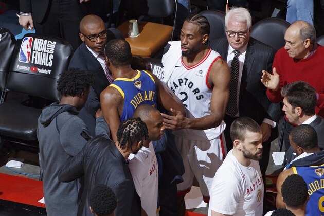 TORONTO, CANADA - JUNE 10: Kawhi Leonard #2 of the Toronto Raptors talks to Kevin Durant #35 of the Golden State Warriors after sustaining an injury during Game Five of the NBA Finals against the Toronto Raptors on June 10, 2019 at Scotiabank Arena in Toronto, Ontario, Canada. NOTE TO USER: User expressly acknowledges and agrees that, by downloading and/or using this photograph, user is consenting to the terms and conditions of the Getty Images License Agreement. Mandatory Copyright Notice: Copyright 2019 NBAE (Photo by Mark Blinch/NBAE via Getty Images)