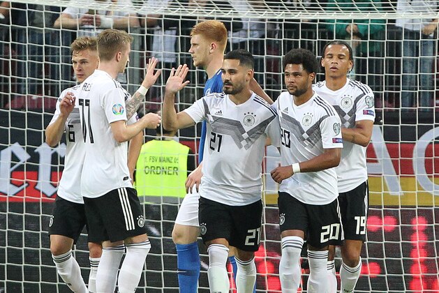 Germany's midfielder Ilkay Gundogan (C) celebrates scoring the 4-0 goal from the penalty spot with his teammates during the UEFA Euro 2020 qualifier Group C football match Germany against Estonia on June 11, 2019 in Mainz. (Photo by Daniel ROLAND / AFP)        (Photo credit should read DANIEL ROLAND/AFP/Getty Images)