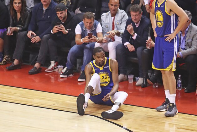 TORONTO,ONTARIO - JUNE 10:  Kevin Durant #35 of the Golden State Warriors goes down with an apparent achilles injury during action against the Toronto Raptors in Game Five of the 2019 NBA Finals at Scotiabank Arena on June 10, 2019 in Toronto, Canada. NOTE TO USER: User expressly acknowledges and agrees that, by downloading and or using this photograph, User is consenting to the terms and conditions of the Getty Images License Agreement. (Photo by Claus Andersen/Getty Images)
