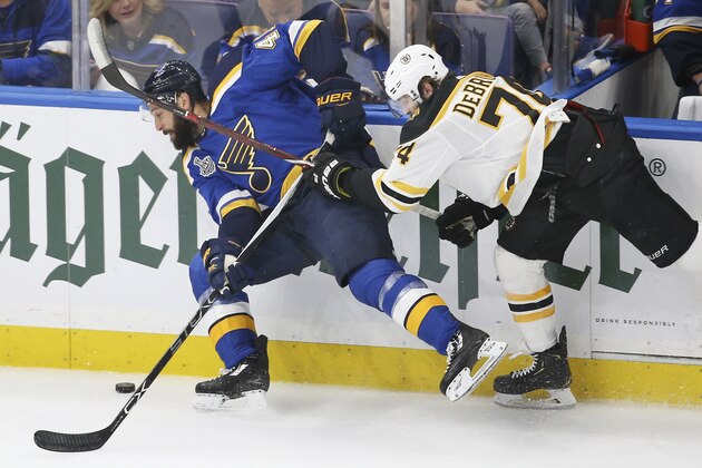 Boston Bruins left wing Jake DeBrusk (74) tries to stop St. Louis Blues defenseman Robert Bortuzzo, left, during the second period of Game 6 of the NHL hockey Stanley Cup Final Sunday, June 9, 2019, in St. Louis. (AP Photo/Scott Kane)