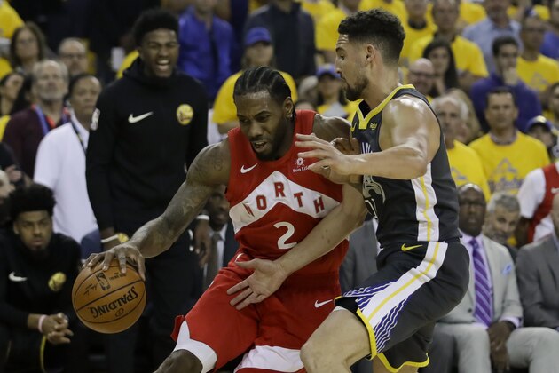 Toronto Raptors forward Kawhi Leonard (2) drives against Golden State Warriors guard Klay Thompson during the first half of Game 4 of basketball's NBA Finals in Oakland, Calif., Friday, June 7, 2019. (AP Photo/Ben Margot)