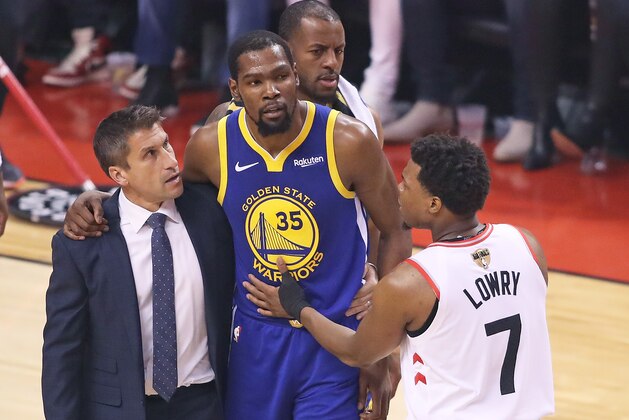 TORONTO,ONTARIO - JUNE 10:  Kyle Lowry #7 of the Toronto Raptors consoles and injured Kevin Durant #35 of the Golden State Warriors during Game Five of the 2019 NBA Finals at Scotiabank Arena on June 10, 2019 in Toronto, Canada. NOTE TO USER: User expressly acknowledges and agrees that, by downloading and or using this photograph, User is consenting to the terms and conditions of the Getty Images License Agreement. (Photo by Claus Andersen/Getty Images)