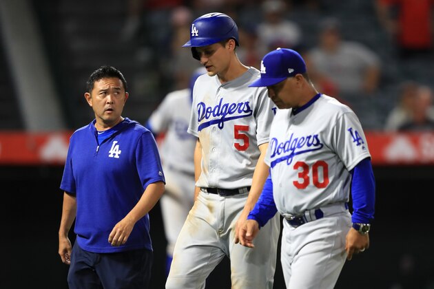 ANAHEIM, CALIFORNIA - JUNE 11:  Manager Dave Roberts and team trainer walk Corey Seager #5 of the Los Angeles Dodgers off the field after he was injured rounding third base during the ninth inning of a game against the Los Angeles Dodgers  at Angel Stadium of Anaheim on June 11, 2019 in Anaheim, California. (Photo by Sean M. Haffey/Getty Images)