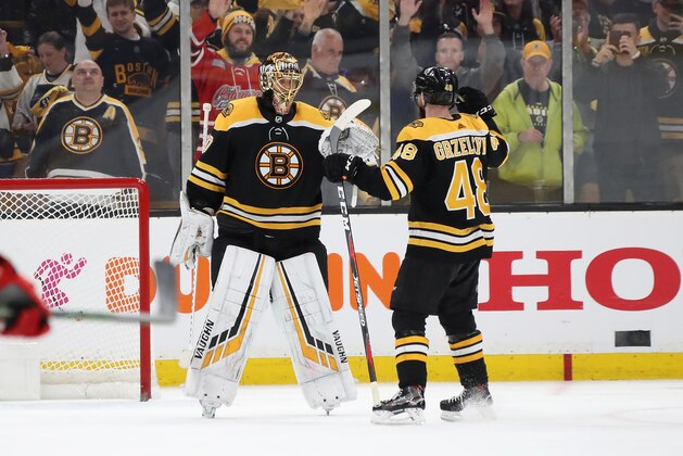 BOSTON, MASSACHUSETTS - MAY 09: Tuukka Rask #40 celebrates with Matt Grzelcyk #48 of the Boston Bruins after defeating the Carolina Hurricanes 5-2 in Game One of the Eastern Conference Final during the 2019 NHL Stanley Cup Playoffs at TD Garden on May 09, 2019 in Boston, Massachusetts. (Photo by Bruce Bennett/Getty Images)