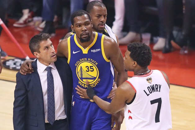 TORONTO,ONTARIO - JUNE 10:  Kyle Lowry #7 of the Toronto Raptors consoles and injured Kevin Durant #35 of the Golden State Warriors during Game Five of the 2019 NBA Finals at Scotiabank Arena on June 10, 2019 in Toronto, Canada. NOTE TO USER: User expressly acknowledges and agrees that, by downloading and or using this photograph, User is consenting to the terms and conditions of the Getty Images License Agreement. (Photo by Claus Andersen/Getty Images)