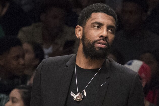 Boston Celtics guard Kyrie Irving watches the game action from the bench during the second half of an NBA basketball game against the Brooklyn Nets, Saturday, March 30, 2019, in New York. The Nets won 110-96. (AP Photo/Mary Altaffer)