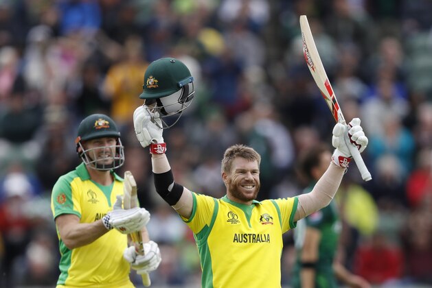 Australia's David Warner, right, celebrates after getting 100 runs not out during the Cricket World Cup match between Australia and Pakistan at the County Ground in Taunton, south west England, Wednesday, June 12, 2019. (AP Photo/Alastair Grant)