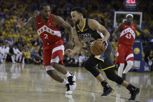 Golden State Warriors guard Stephen Curry (30) drives against Toronto Raptors forward Kawhi Leonard (2) during the second half of Game 4 of basketball's NBA Finals in Oakland, Calif., Friday, June 7, 2019. (AP Photo/Ben Margot)