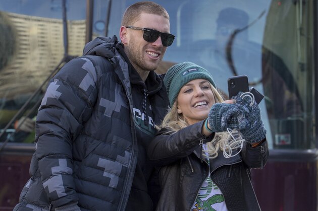 Philadelphia Eagles NFL football player Zach Ertz, left, stops to take a photo with his wife, Julie Ertz, during a Super Bowl victory parade, Thursday, Feb. 8, 2018, in Philadelphia. The Eagles beat the New England Patriots 41-33 in Super Bowl 52. (AP Photo/Christopher Szagola)