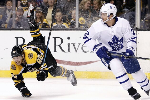 Boston Bruins' David Pastrnak, left, is upended by Toronto Maple Leafs' Nikita Zaitsev during the second period of Game 2 of an NHL hockey first-round playoff series in Boston, Saturday, April 14, 2018. (AP Photo/Winslow Townson)