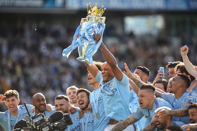 BRIGHTON, ENGLAND - MAY 12: Vincent Kompany of Manchester City with the premier league trophy during the celebrations of becoming 2019 Champions after the Premier League match between Brighton & Hove Albion and Manchester City at American Express Community Stadium on May 12, 2019 in Brighton, United Kingdom. (Photo by Matthew Ashton - AMA/Getty Images)