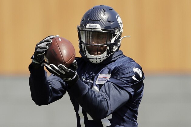 In this Friday, May 3, 2019 photo, Seattle Seahawks rookie wide receiver DK Metcalf makes a catch during NFL football rookie mini camp in Renton, Wash. It took one rookie minicamp practice for Metcalf to catch the attention of Seahawks coach Pete Carroll.