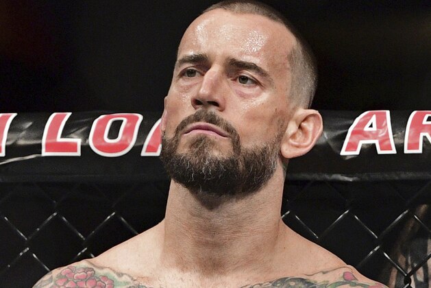 FILE - In this Sept. 10, 2016, file photo, CM Punk stands in his corner before a welterweight bout at UFC 203 in Cleveland. Punk went 0-2 in UFC and has given himself until the new year to decide if he wants to keep fighting. Punk hopes to stick in the sport as a mixed martial arts announcer. (AP Photo/David Dermer, File)