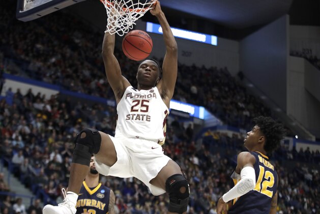 Florida State's Mfiondu Kabengele (25) dunks over Murray State's Ja Morant (12) during the second half of a second round men's college basketball game in the NCAA Tournament, Saturday, March 23, 2019, in Hartford, Conn. Florida State won 90-62. (AP Photo/Elise Amendola)