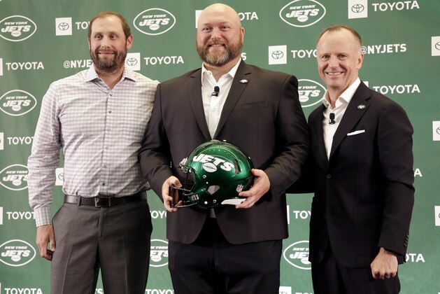 The new New York Jets general manager Joe Douglas, center, poses for a picture with head coach Adam Gase, left, and owner Christopher Johnson during a news conference at the team's NFL football training facility in Florham Park, N.J., Tuesday, June 11, 2019. (AP Photo/Seth Wenig)