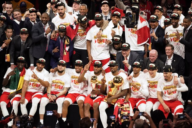 Toronto Raptors players and coaches celebrate after the Raptors defeated the Golden State Warriors in Game 6 of basketball's NBA Finals in Oakland, Calif., Thursday, June 13, 2019. (AP Photo/Tony Avelar)