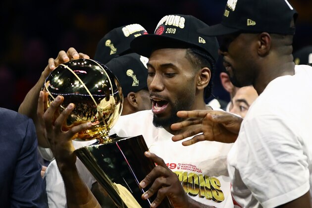 OAKLAND, CALIFORNIA - JUNE 13:  Kawhi Leonard #2 of the Toronto Raptors celebrates with the Larry O'Brien Championship Trophy after his team defeated the Golden State Warriors to win Game Six of the 2019 NBA Finals at ORACLE Arena on June 13, 2019 in Oakland, California. NOTE TO USER: User expressly acknowledges and agrees that, by downloading and or using this photograph, User is consenting to the terms and conditions of the Getty Images License Agreement. (Photo by Ezra Shaw/Getty Images)