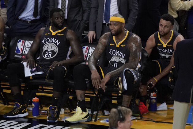 Golden State Warriors forward Draymond Green (23) sits on the bench next to center DeMarcus Cousins (0) and guard Stephen Curry (30) during the second half of Game 6 of basketball's NBA Finals against the Toronto Raptors in Oakland, Calif., Thursday, June 13, 2019. (AP Photo/Tony Avelar)