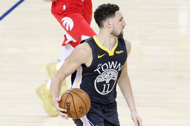 OAKLAND, CA - JUNE 13:  Klay Thompson #11 of the Golden State Warriors handles the ball against the Toronto Raptors during Game Six of the NBA Finals on June 13, 2019 at ORACLE Arena in Oakland, California. NOTE TO USER: User expressly acknowledges and agrees that, by downloading and/or using this photograph, user is consenting to the terms and conditions of Getty Images License Agreement. Mandatory Copyright Notice: Copyright 2019 NBAE (Photo by Joe Murphy/NBAE via Getty Images)